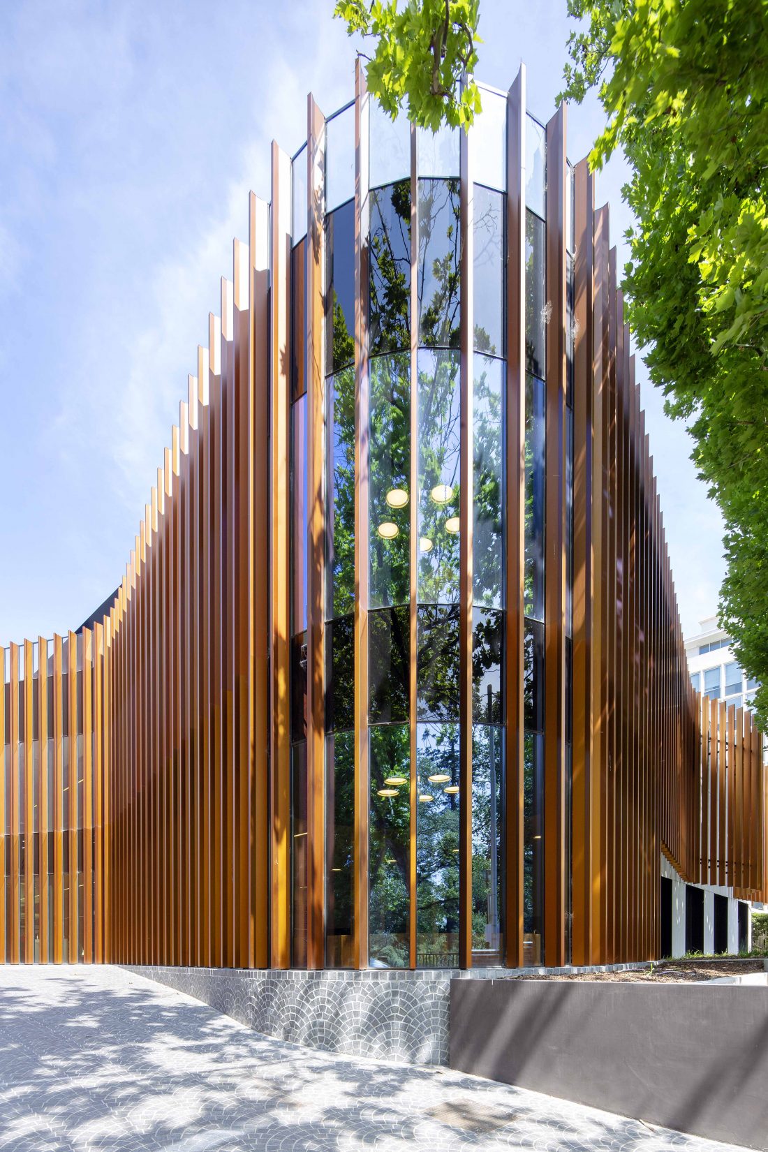 Exterior architecture photography of a college wellness centre, showcasing clean lines, natural landscaping, and inviting entrance, capturing the serenity of the space.