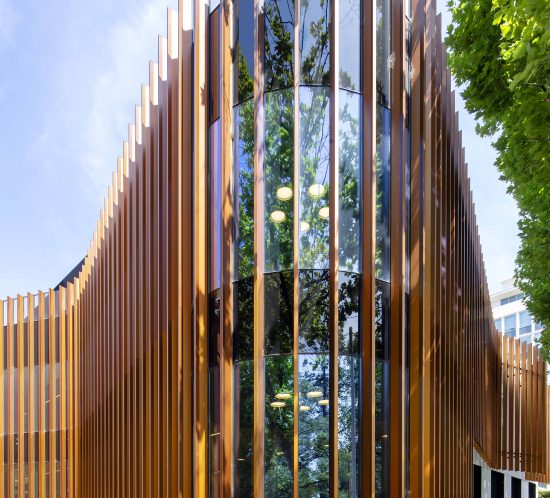 Exterior architecture photography of a college wellness centre, showcasing clean lines, natural landscaping, and inviting entrance, capturing the serenity of the space.