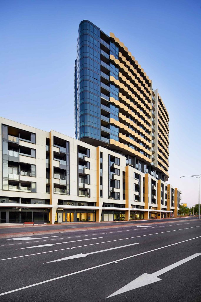 Exterior view of a sleek and contemporary apartment tower in the Melbourne suburbs.