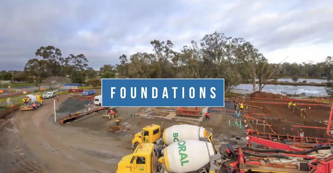 A construction video showing the process of building foundations, with workers and machinery in action.