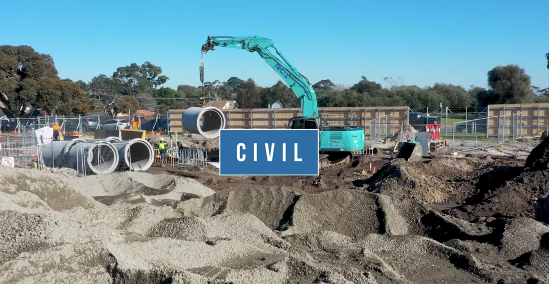 Civil construction site with excavator lifting concrete pipe, stockpiles and “Civil” title overlay.