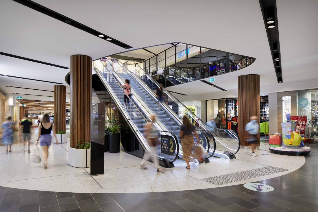 Image depicting the interior architecture of a shopping centre captured through photography, showcasing modern design elements and spacious atriums.