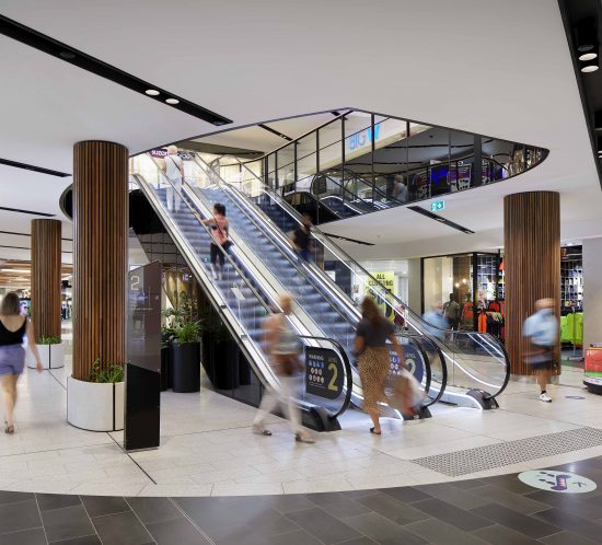 Image depicting the interior architecture of a shopping centre captured through photography, showcasing modern design elements and spacious atriums.