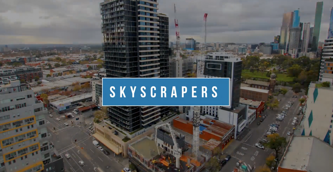 A time-lapse image showing the construction of a towering skyscraper, with cranes and construction workers moving about.