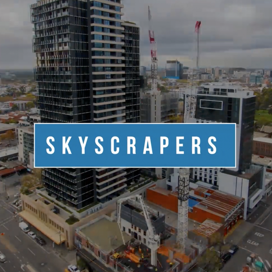 A time-lapse image showing the construction of a towering skyscraper, with cranes and construction workers moving about.