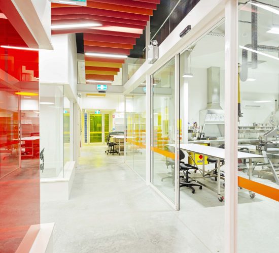 Interior architecture images of an art college showcasing soaring ceilings, vibrant colors, and expansive studio areas, capturing the creativity and inspiration of the space.